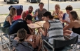 group gathered around table playing cards