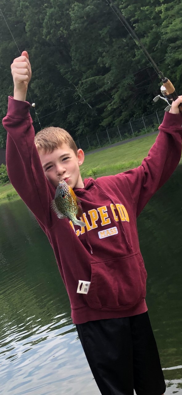 Kid showing fish he caught