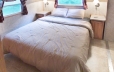 The master bedroom has a queen size bed with TV and ample storage space
