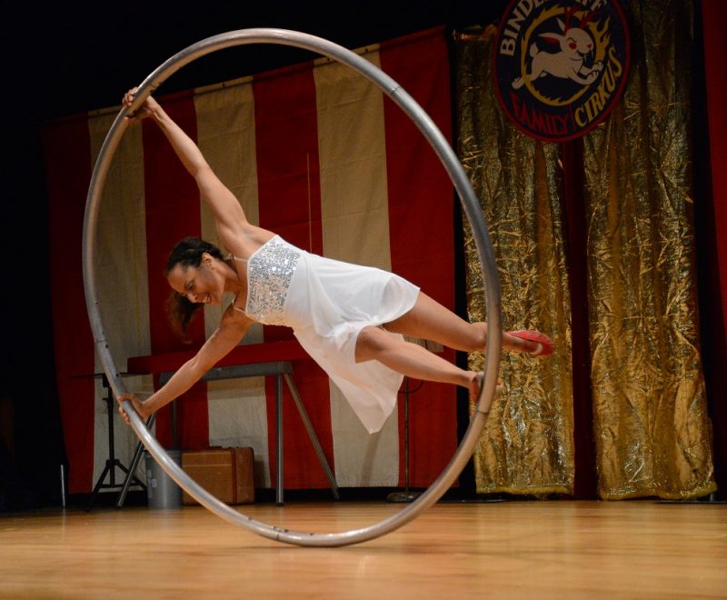 Performer holding onto large ring