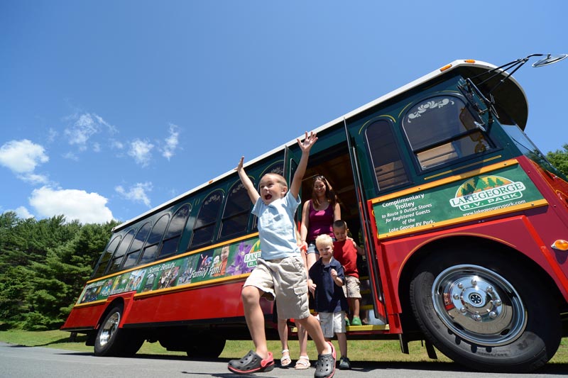 excited family getting off trolley