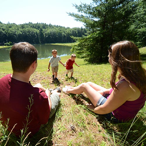 Family of four siting by the fishing pond