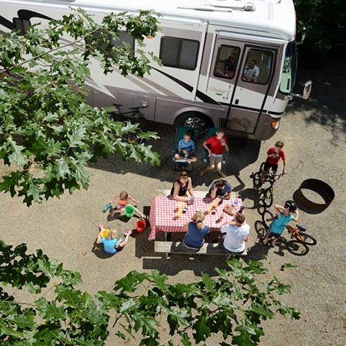Above view of family hanging out and relaxing at their campsite.