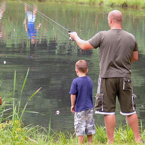 Father and son fishing in our fishing pond