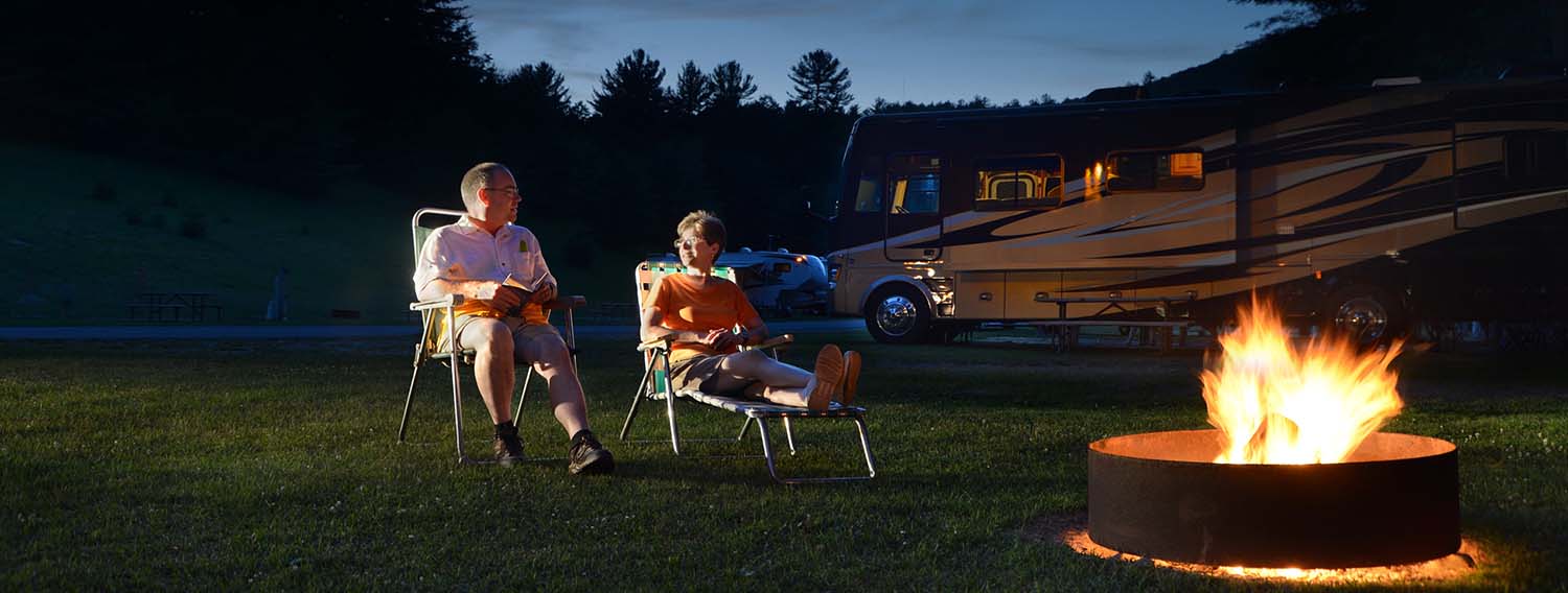 Guest enjoying a campfire onsite in our complimentary fire ring