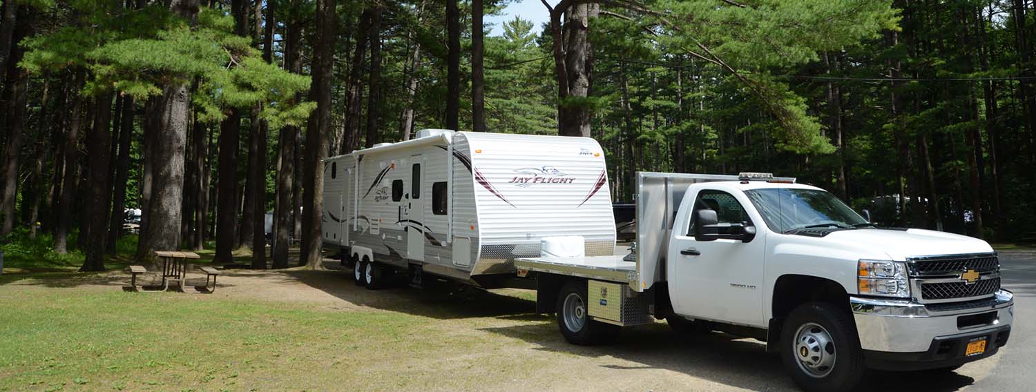 RV trailer backing into campsite