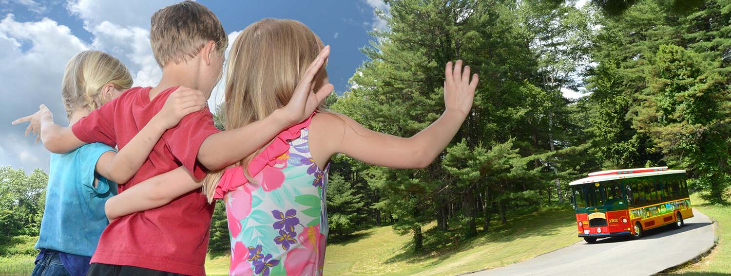 Children waving at the Trolley driving by