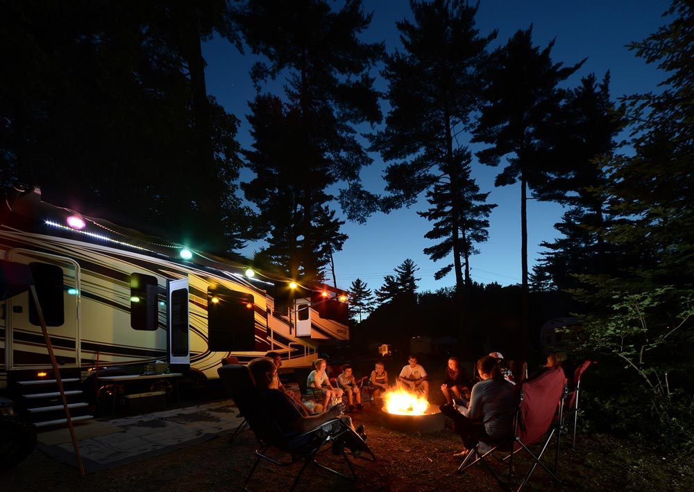 Campers gathered outside RV at night