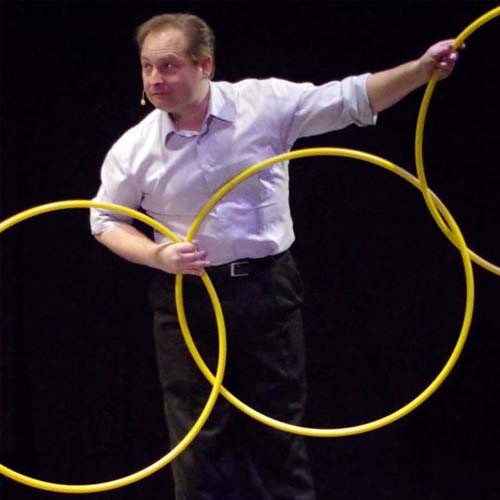 Man holding hula hoops that are looped together