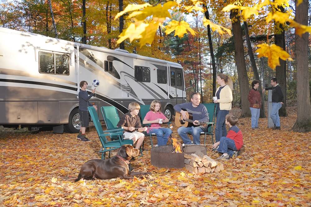 Family playing music around the campfire