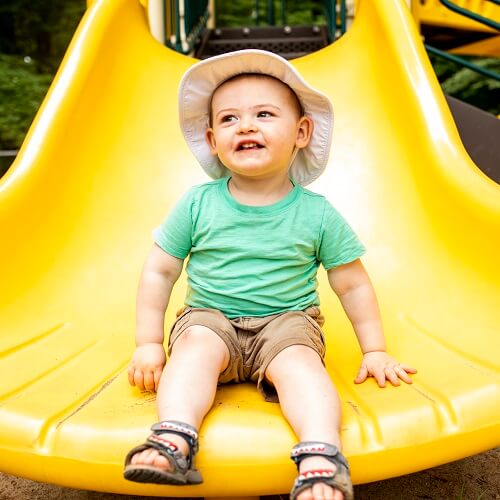 Toddler at the end of slide