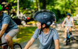 Young boy riding his bike wearing a spiky helmet