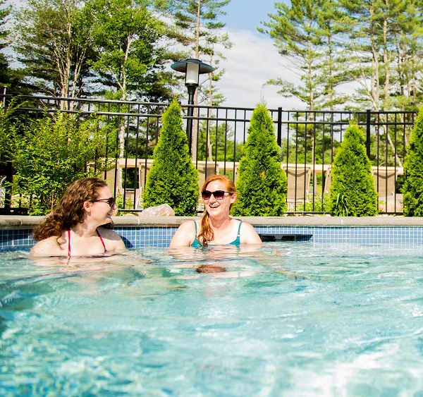 2 women enjoying hot tub