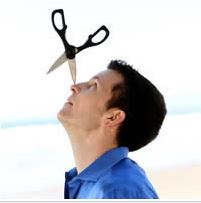 Bryson Lang balancing pointed scissors on his nose with a beach in the background