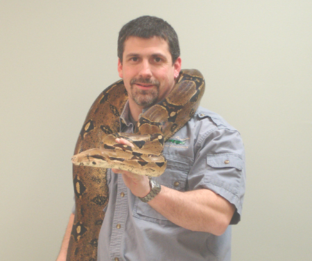 Bingo Pavilion artists, Mark Perpetua with an anaconda sitting on his shoulders.