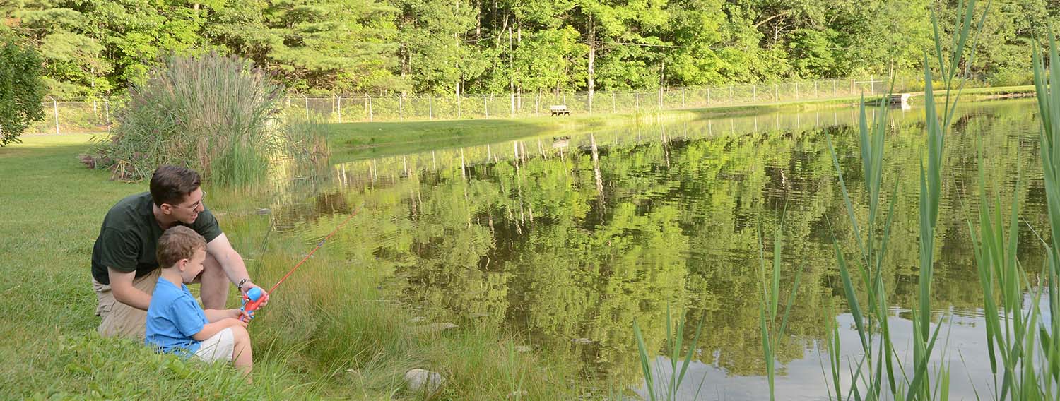 Father and son fishing at the pond