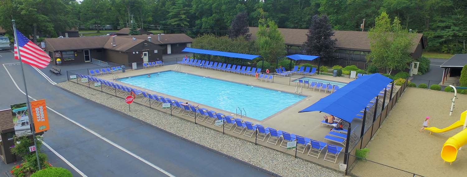 Pool surrounded by chairs on deck