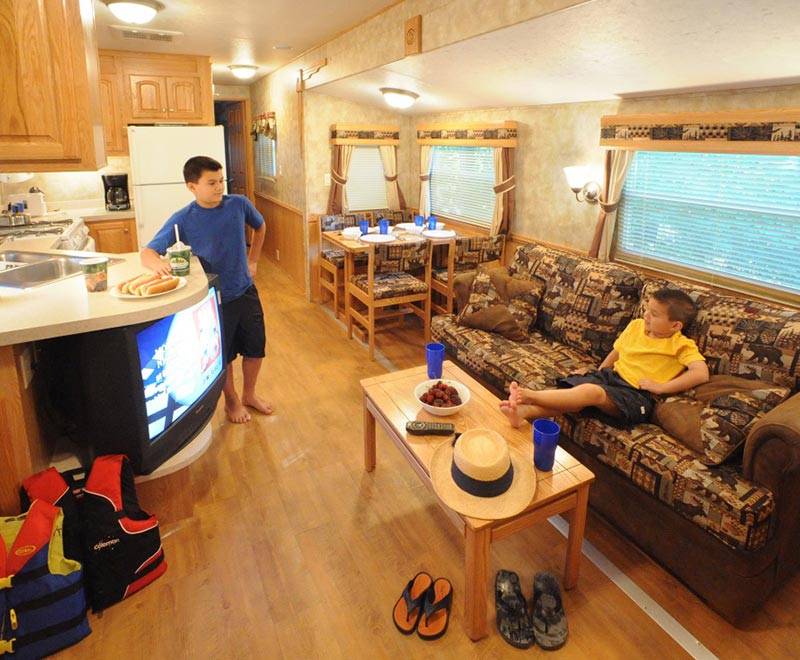 2 kids hanging out inside camping trailer