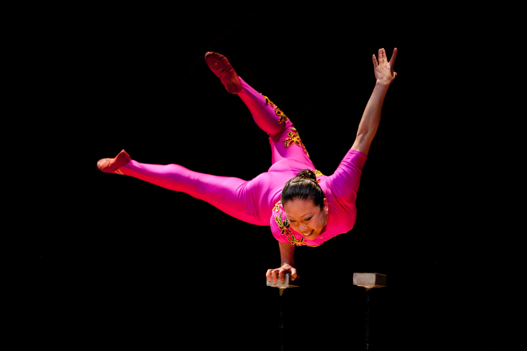 A performer is balancing on one hand
