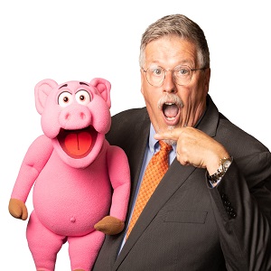 Ventriloquist Al Getler posing with a pig puppet