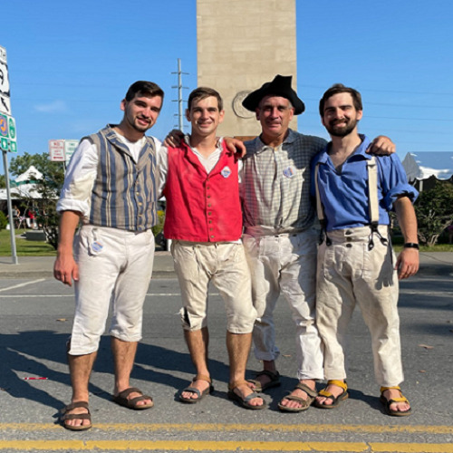 Four men posing for a picture