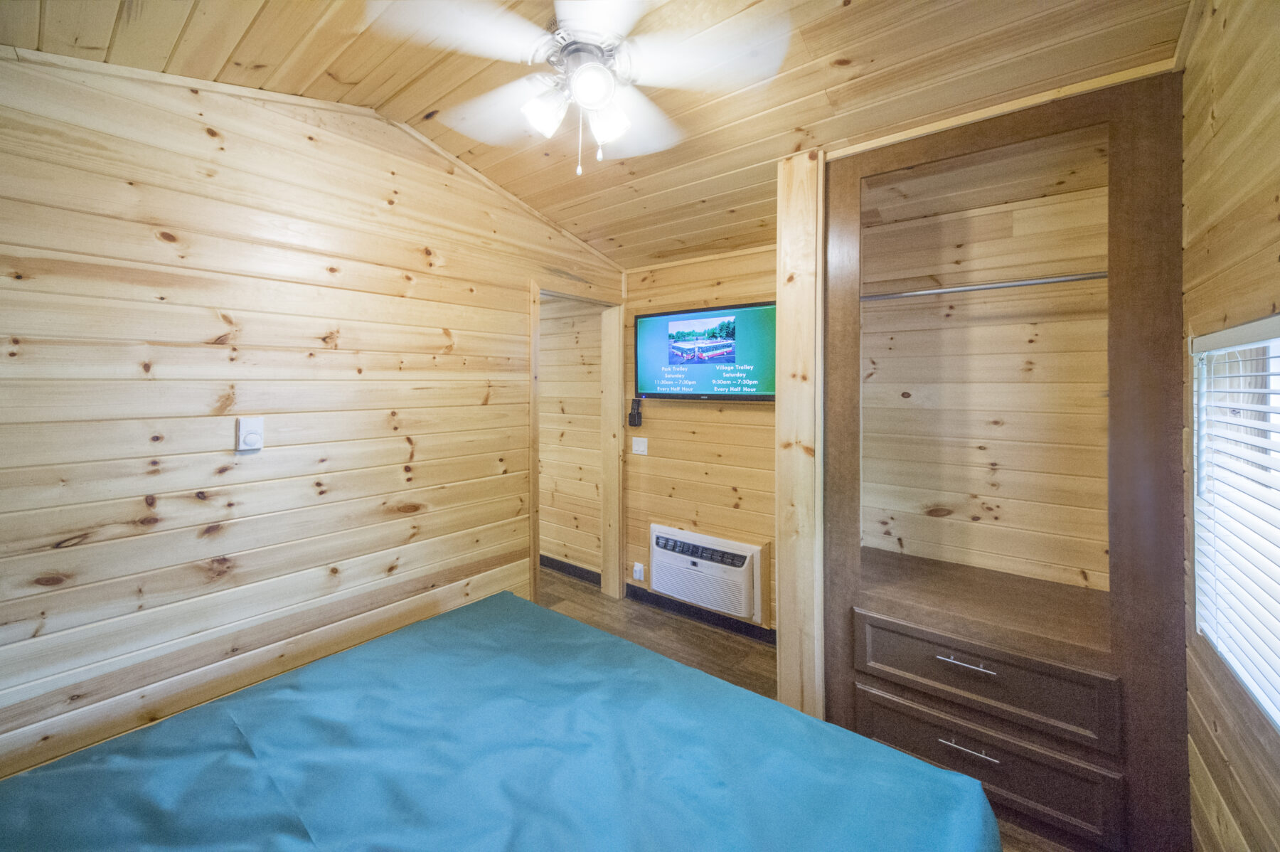 Bedroom in cabin featuring a queen bed, television and closet