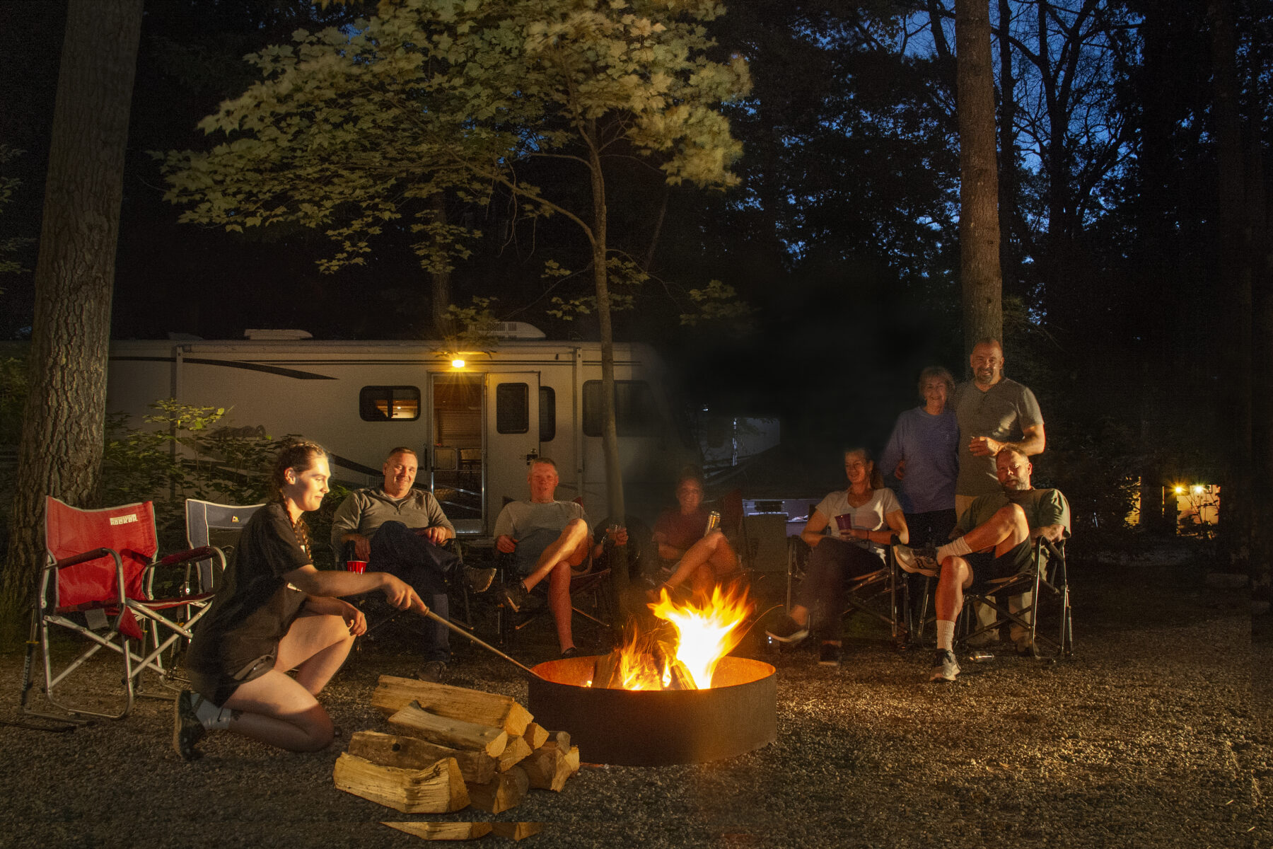 Family sitting around campfire