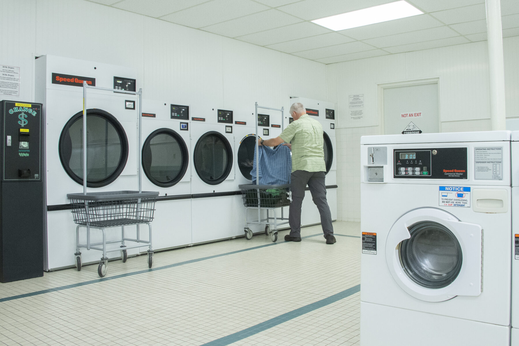 Guest doing laundry in the East Building Laundromat
